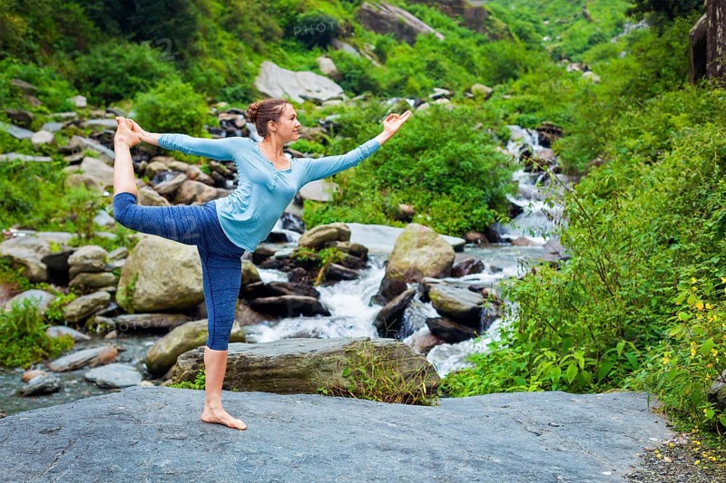 Woman doing yoga asana Natarajasana