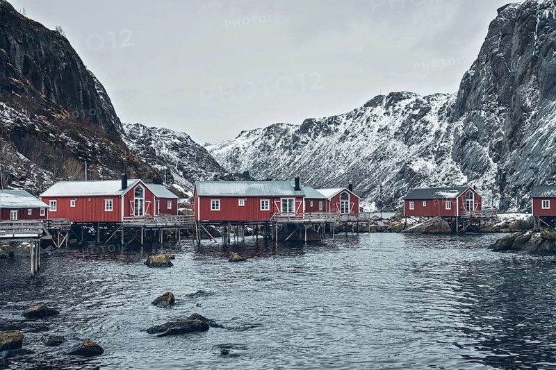 Nusfjord authentic traditional fishing village with traditional red rorbu houses in winter in Norwegian fjord. Lofoten islands