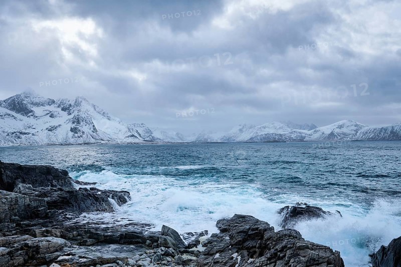 Waves of Norwegian sea crushing at rocky coast in fjord. Vikten