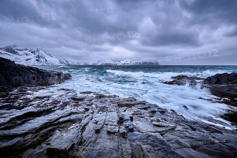Waves of Norwegian sea crushing at rocky coast in fjord. Vikten