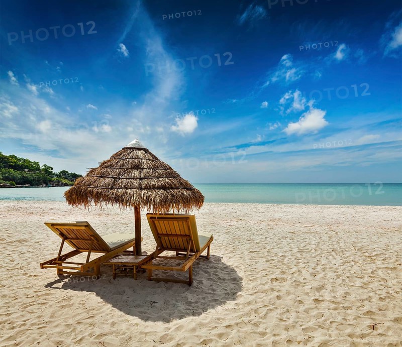 Two beach lounge chairs under tent on beach. Sihanoukville
