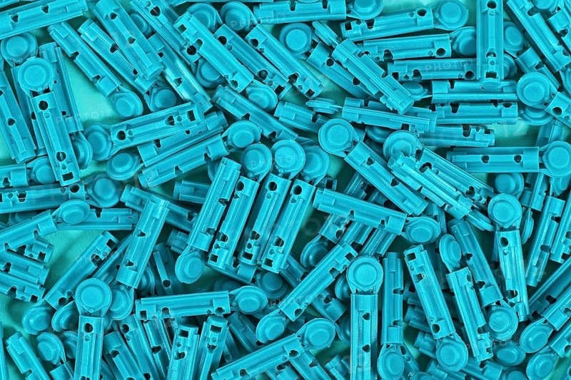 Many blue disposable diabetes lancets used to draw blood for testing