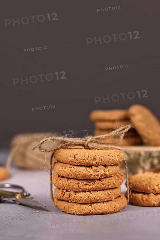 Stack of healthy homemade oat cookies in front of gray background