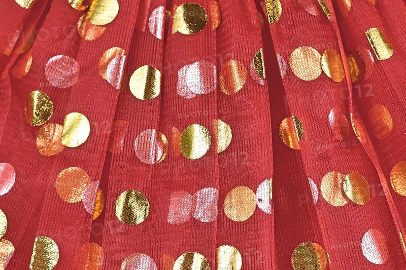 Tulle with golden polka dots on red fabric