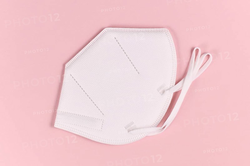 Medical FFP2 respirator mask on pink background