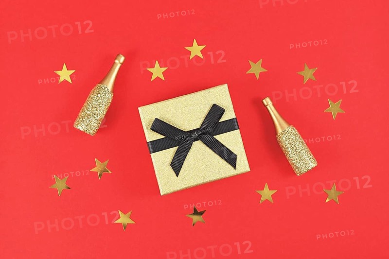 Golden gift box with black bow