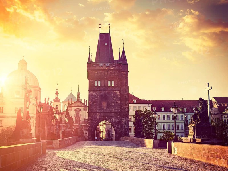 Vintage retro hipster style travel image of Charles bridge old town tower in Prague on sunrise