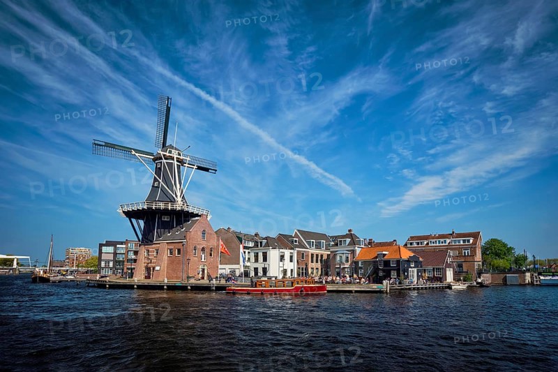 View of Harlem landmark windmill De Adriaan on Spaarne river. Harlem