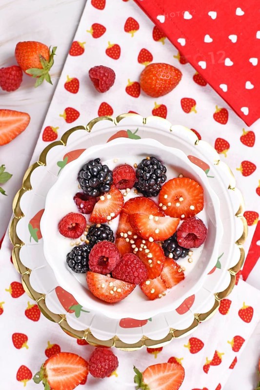 Top view of berry mix yogurt bowl with strawberry
