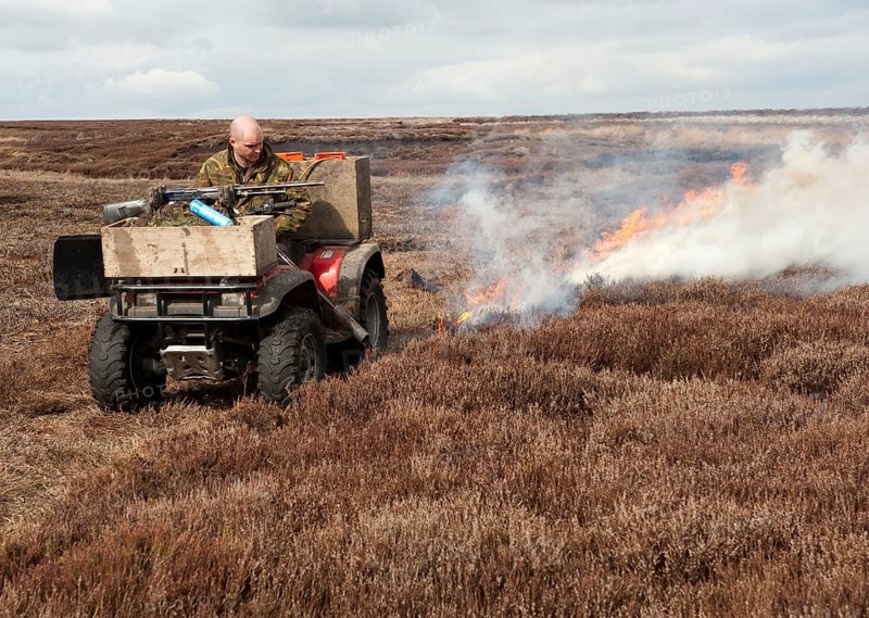 Gamekeepers burning heather on moorland to encourage new growth for grouse