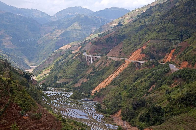 Chinese motorway and terraced rice paddies on the hillside in Yunnan Province