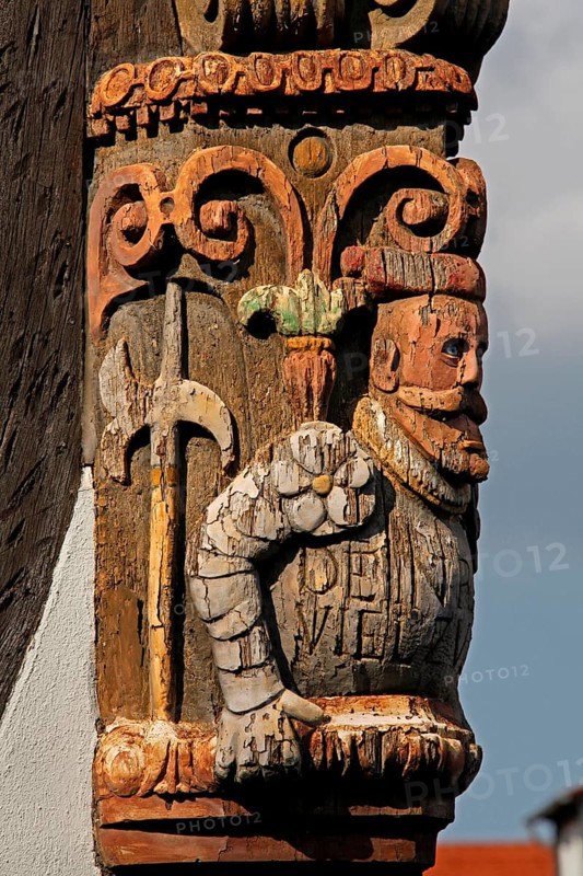 Artful carvings on corner beams of half-timbered house