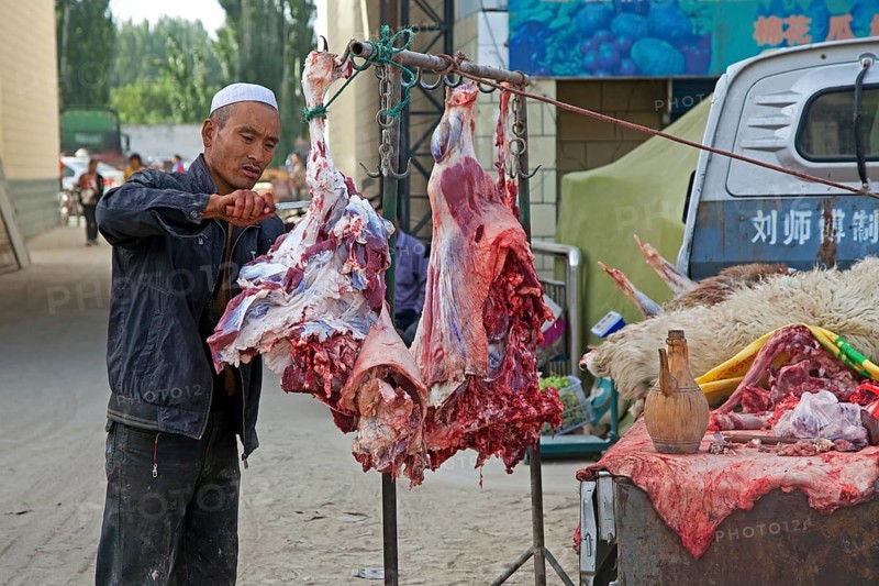Mobile butcher cutting meat from his pickup truck in Waxxari village