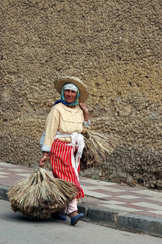 Old Berber woman carrying goods to market in Tetouan