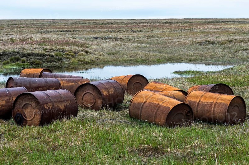 Rusted barrels in the tundra