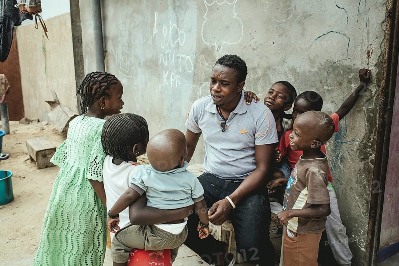 Fisherman and Captain Mukhtar in his house with various family members