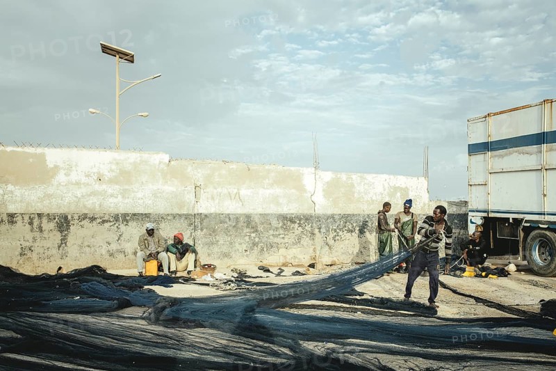 Fishermen repairing nets