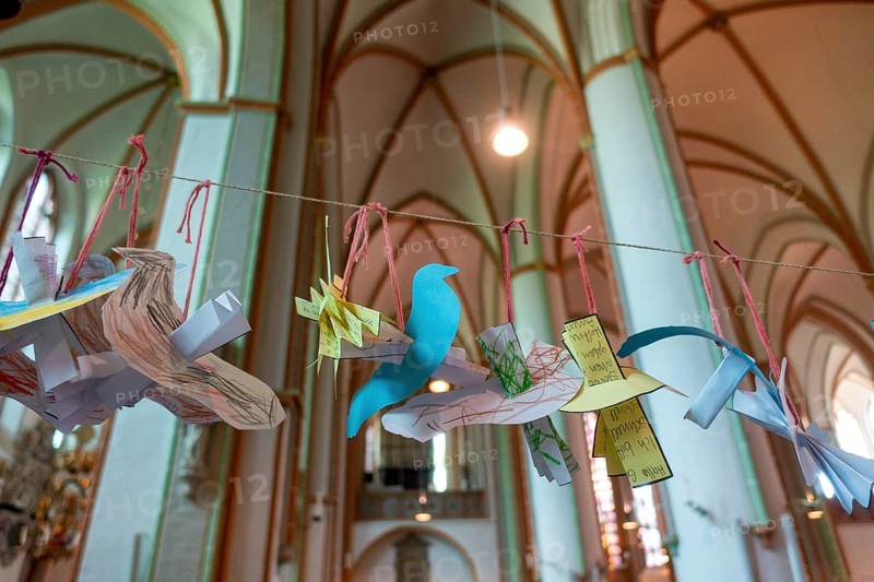 Peace doves made of paper hang in the main Protestant church St. Johannis