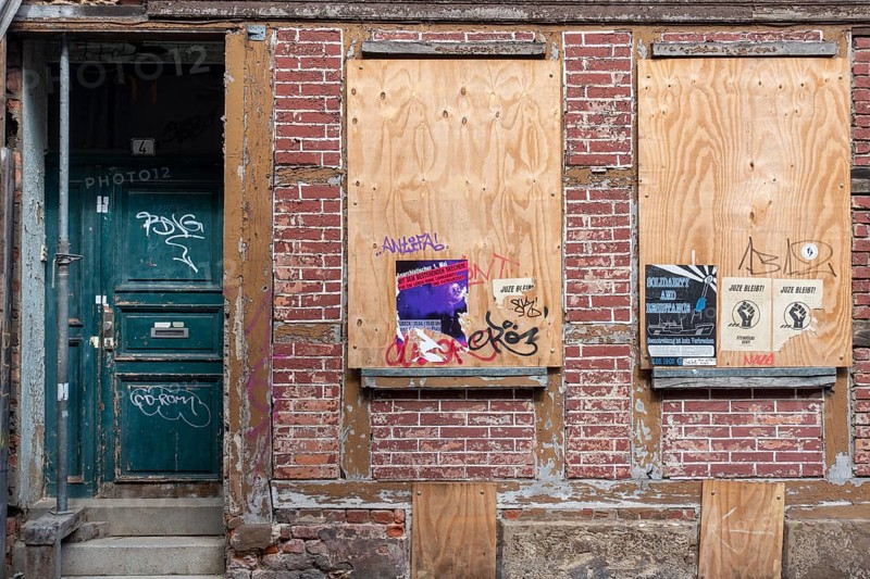 Boarded-up windows of an unoccupied house