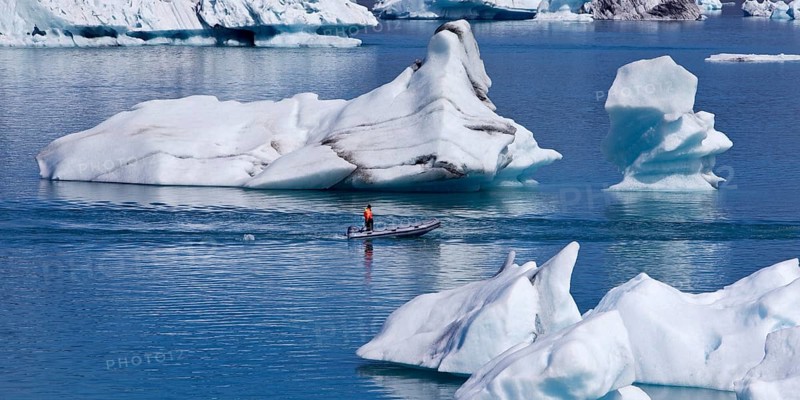 Rubber dinghy in front of icebergs in Joekulsarlon glacier lagoon