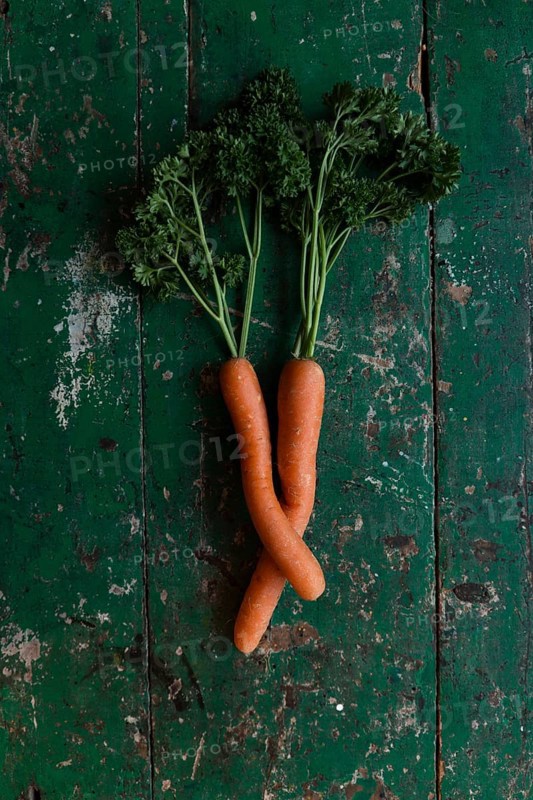 Two carrots bent into each other with parsley