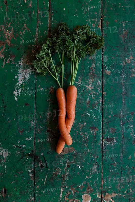 Two carrots bent into each other with parsley