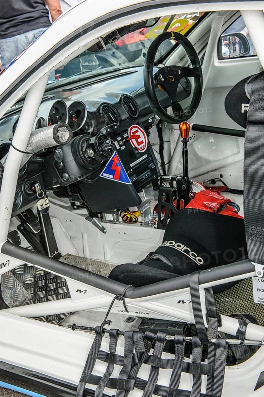 View inside cockpit of racing car Porsche Cayman R in grid lane in front of start of car race