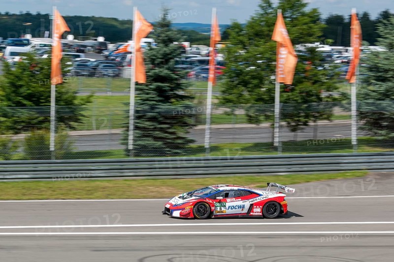 Racing car Lamborghini Huracan GT3 drives at high speed from exit of pit lane onto race track