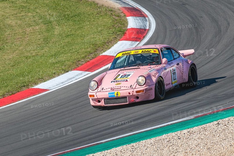 Historic racing car Porsche 911 Carrera RS with historic design paint Sau at car racing for oldtimer youngtimer classic cars 24-hour race 24h race