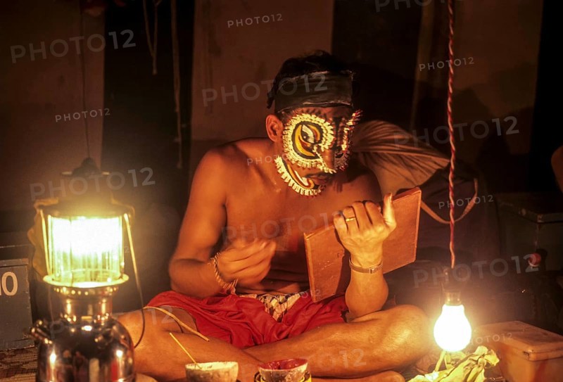 Actor begins to apply the special makeup used in Kathakali