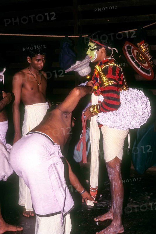 Koodiyattam Kodiyattom actor being fitted with his costume