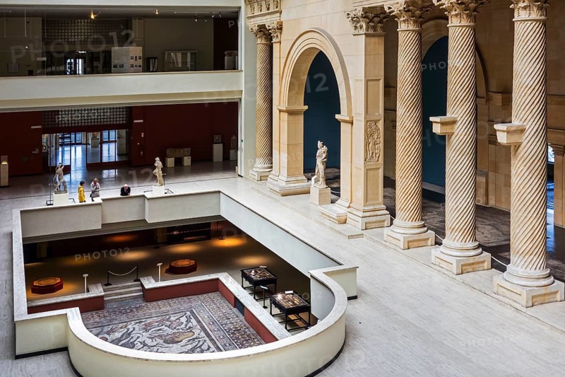 Visitors look at a Roman mosaic from Apamea
