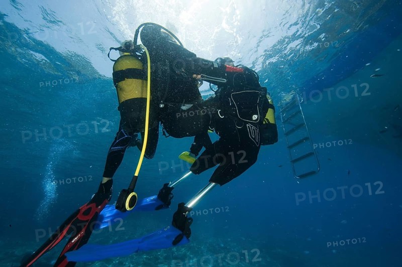 Disabled diver with instructor in sea