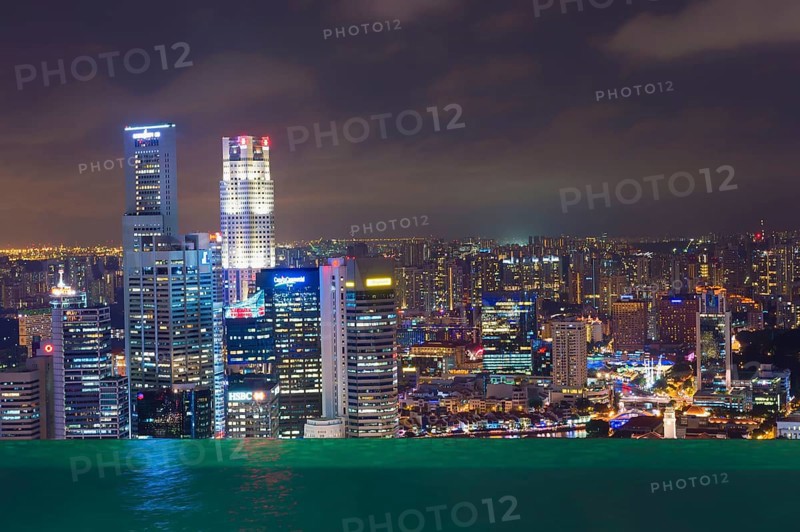 The city's central financial district at night as seen from the infinity pool of the Marina Bay Sands Hotel