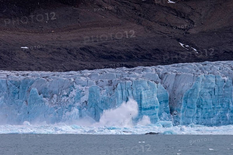Calving ice of the Samarinbreen glacier flowing into Samarinvagen