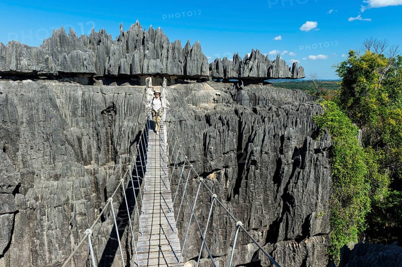 Climber crossing a suspension bridge