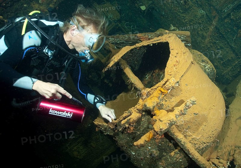 Diver looks into large dough machine in wreck Umbria