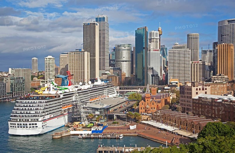 Cruise ship Carnival Spirit docked in Sydney Harbour overlooking the city centre with its colonial buildings and modern skyscrapers