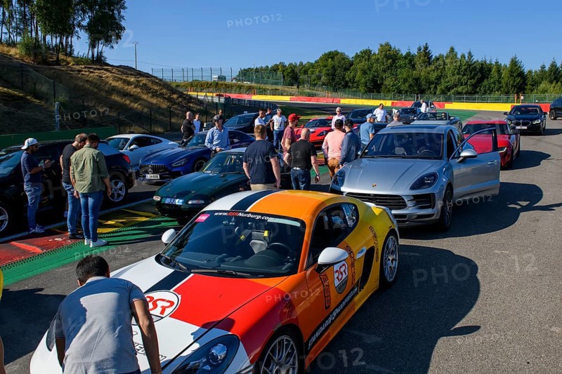 Parked cars of participants of trackday during track inspection of race track for motorsport car racing