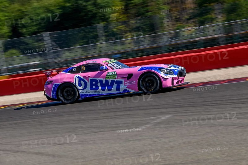 Racing car sports car Mercedes AMG GT3 BWT races at full throttle at exit of corner hairpin La Source of racetrack