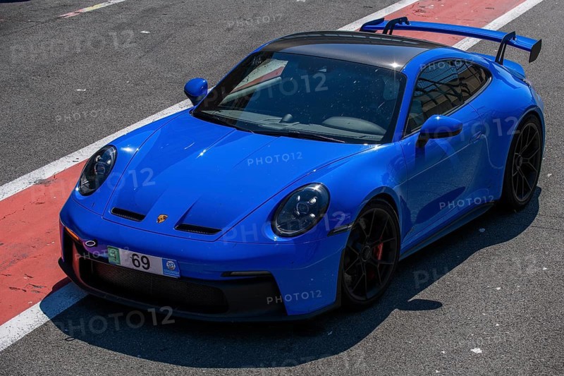 Blue sports car race car Porsche 911 992 GT3 in pit lane pit lane of race track