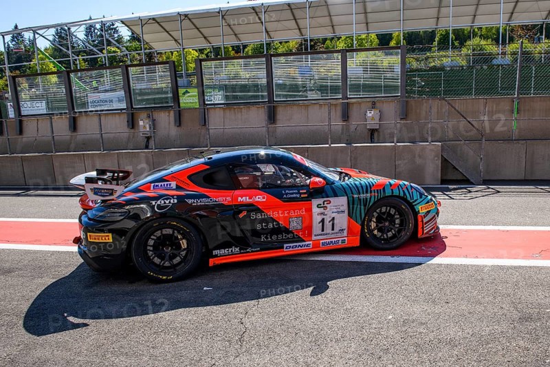 Racing car Porsche Cayman GT4 Clubsport MR drives through pit lane Pit Lane of race track