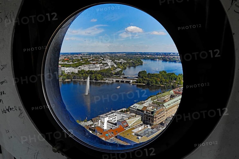 City view of the Inner Alster Lake through the porthole windows in the spire of the Hauptkirche St. Petri