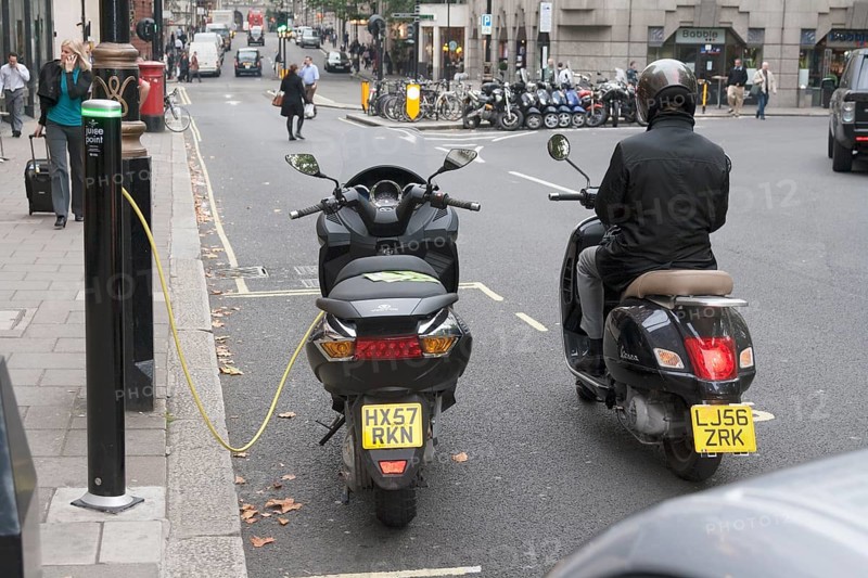 Motorist waiting to recharge his scooter