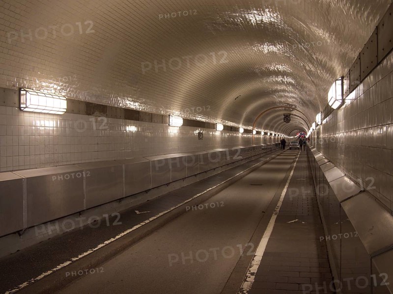Pedestrians and a car cross the west tube of the old Elbe tunnel