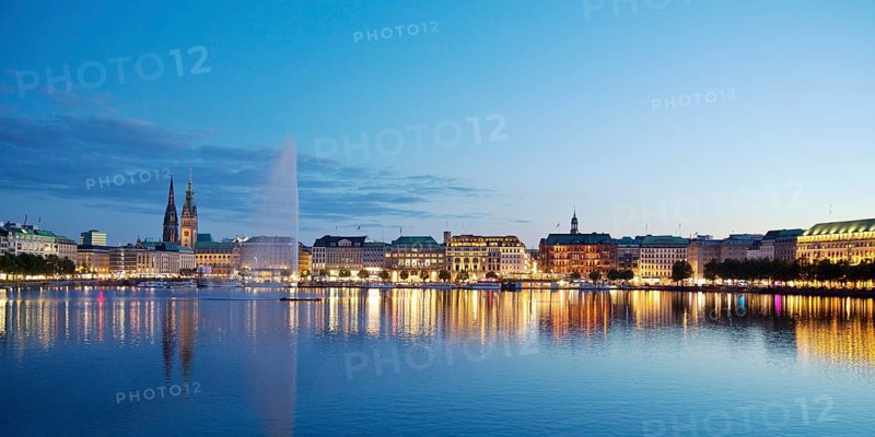Inner Alster with Alsterfontaine and city skyline in the evening