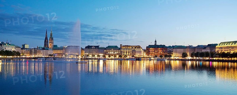 Inner Alster with Alsterfontaine and city skyline in the evening