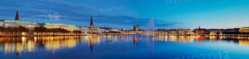 Inner Alster with Alsterfontaine and city skyline in the evening