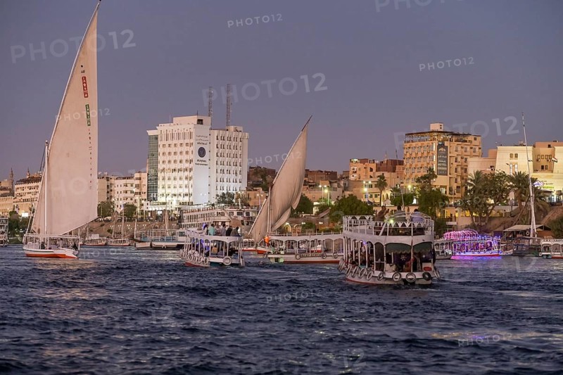 Sailing ships and excursion boats on the evening Nile at Aswan
