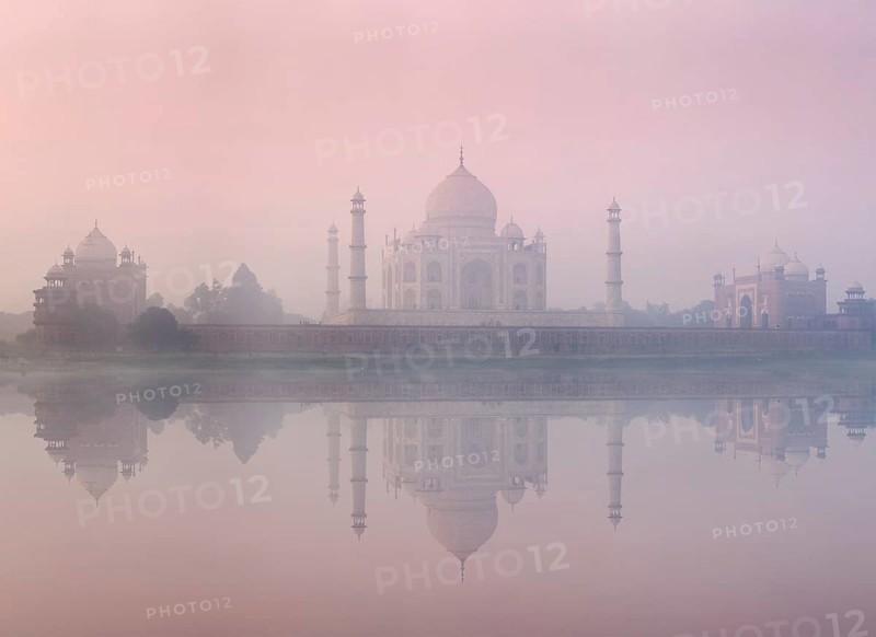 Taj Mahal on sunrise sunset reflection in Yamuna river panorama in fog